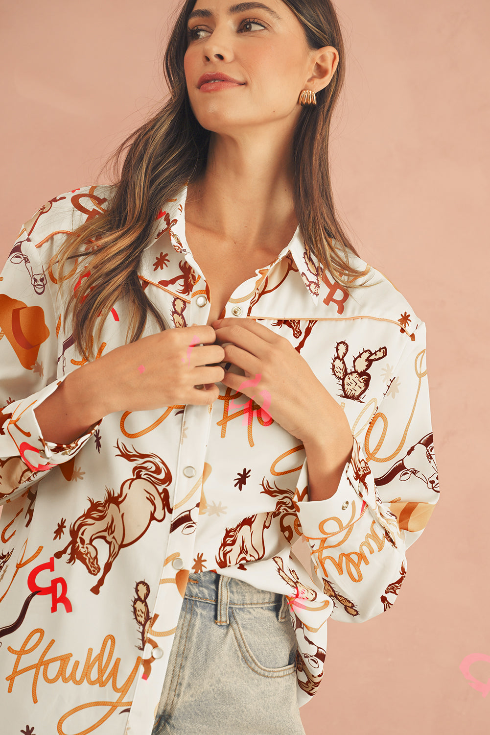 Half front view of a beige Howdy abstract print shirt with long sleeves, highlighting button details.