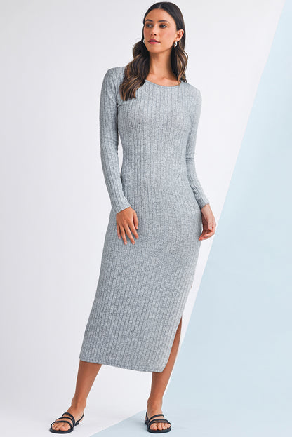 Woman wearing a gray ribbed dress with a white background