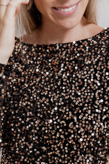 Close-up view of the Chestnut bodycon sequin mini dress with long sleeves, worn by a model, by Catherine Martin, Australia – showcasing the chic, figure-hugging design and luxurious fabric, perfect for evening wear.