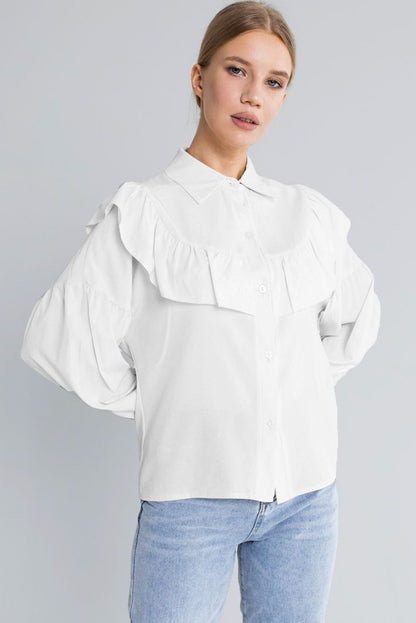 The front view of long sleeve white shirt featuring ruffle chest, this shirt can be styled with jeans and skirt for a complete look.