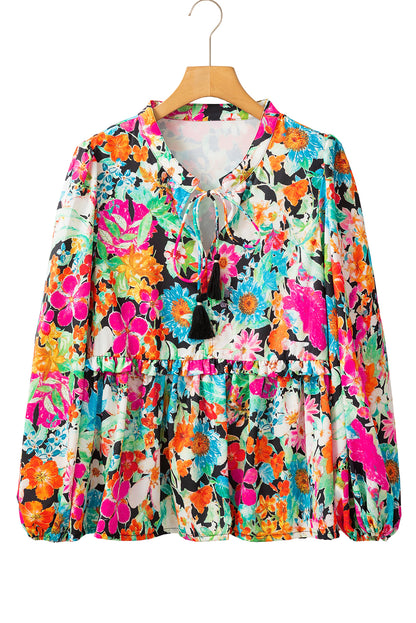 Front view of multicolour floral blouse with long sleeves against a white background.