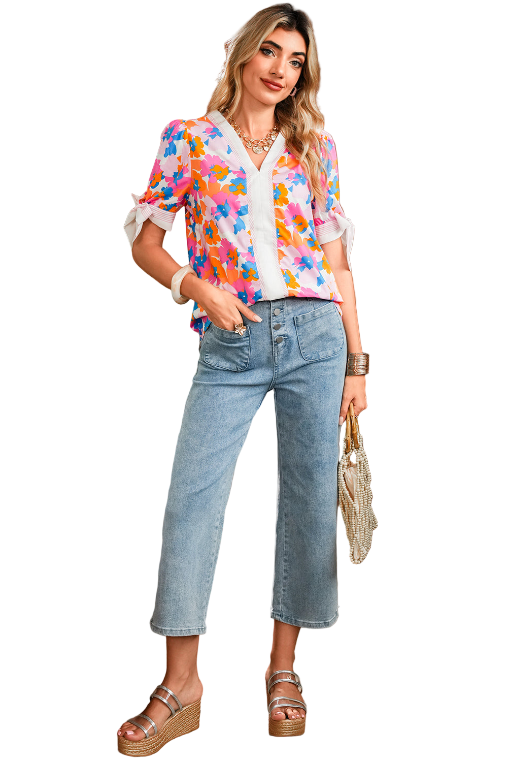 Woman wearing a colorful floral blouse and blue jeans on a white background