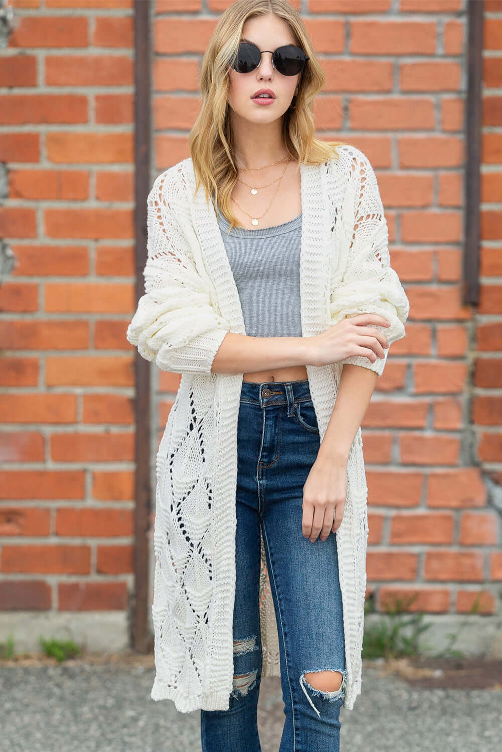 Lightweight open-front crochet cardigan styled over a pair of jeans for a boho-chic look.

