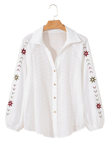 The front view of the white embroidered shirt showcases its puff long sleeves against a white background.