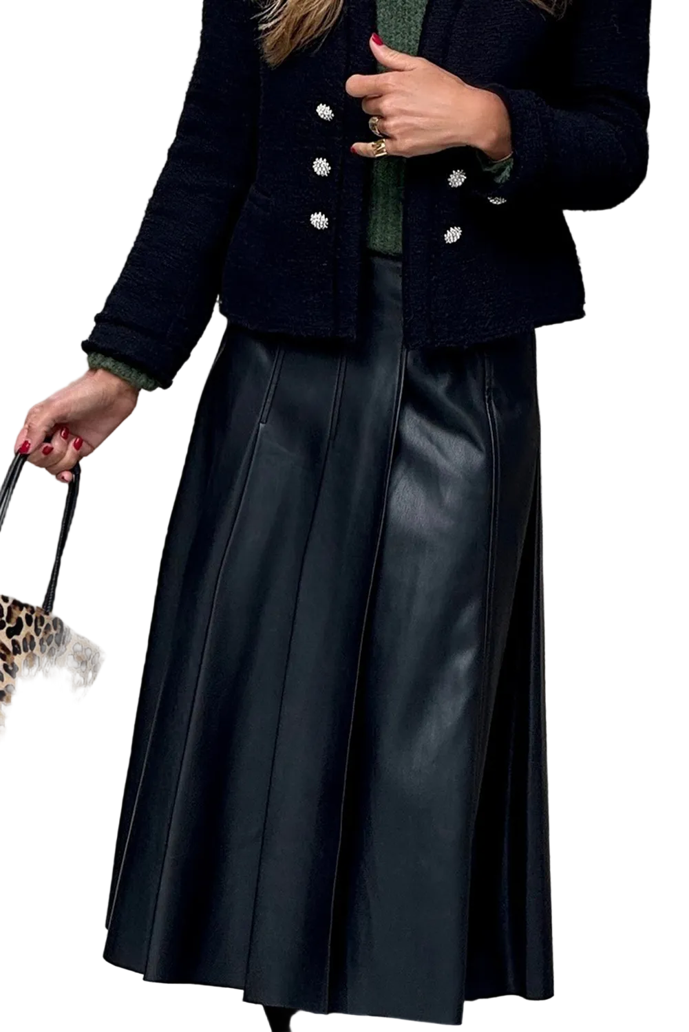 Person wearing a navy blue jacket with white buttons and a black leather skirt, holding a leopard print bag.