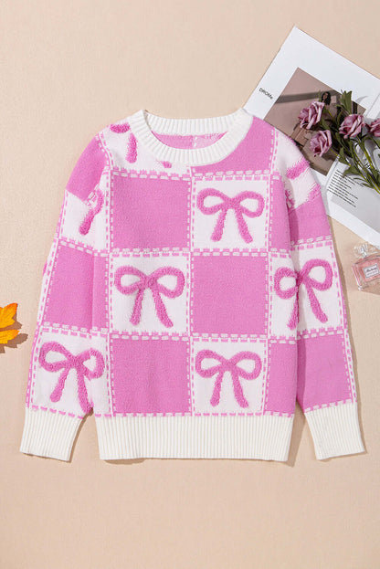Pink bow knit sweater with a relaxed fit, perfect for layering.

