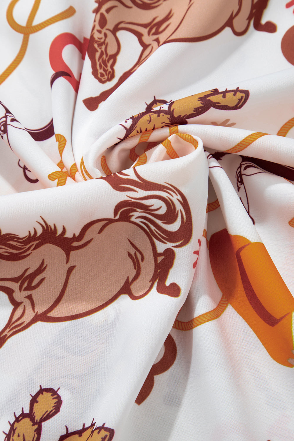 Close-up view of the fabric on a beige Howdy abstract print shirt with long sleeves.