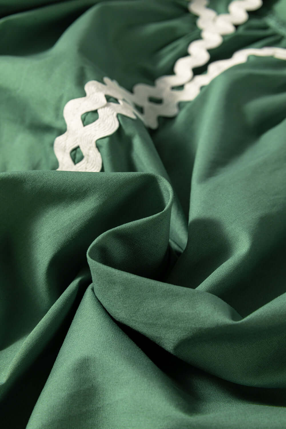 Close-up of the ricrac neckline and tie front on a 100% cotton Mist Green blouse.