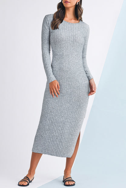 Woman wearing a gray ribbed dress with a white background