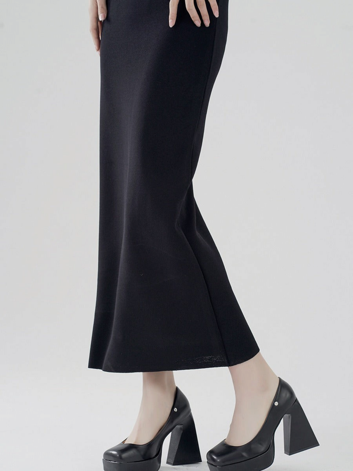 Catherine Martin black viscose-nylon midi skirt with a clean straight silhouette worn with black platform heels