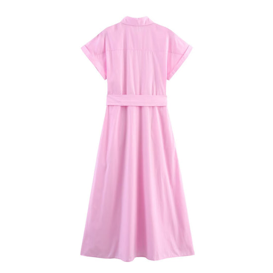 The rear view of the pink maxi shirt dress, showing the clean yoke stitching, the mid-waist belted silhouette, and the flowing A-line skirt.