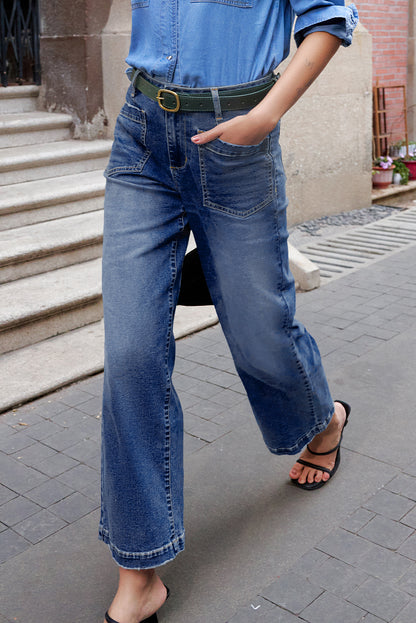 Person wearing blue jeans and a denim shirt on a street.