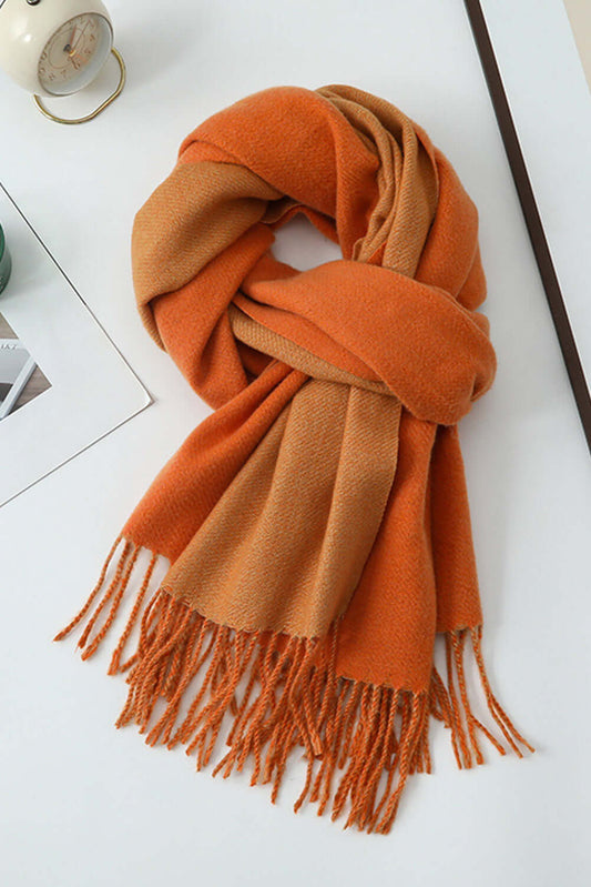 Orange scarf with fringes on a white surface
