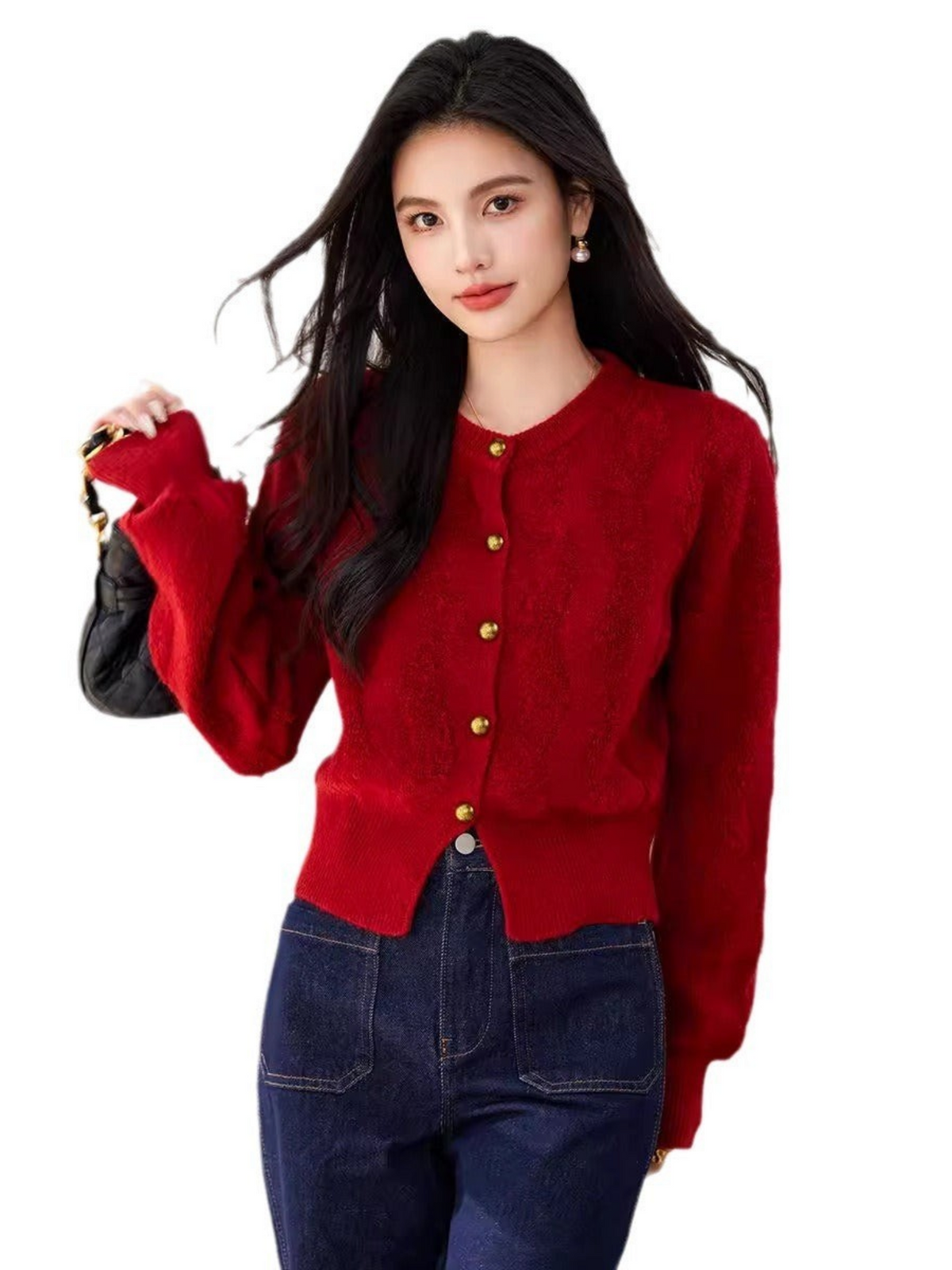 Catherine Martin red textured knit cardigan with gold buttons worn by a model with dark hair and dark blue jeans.
