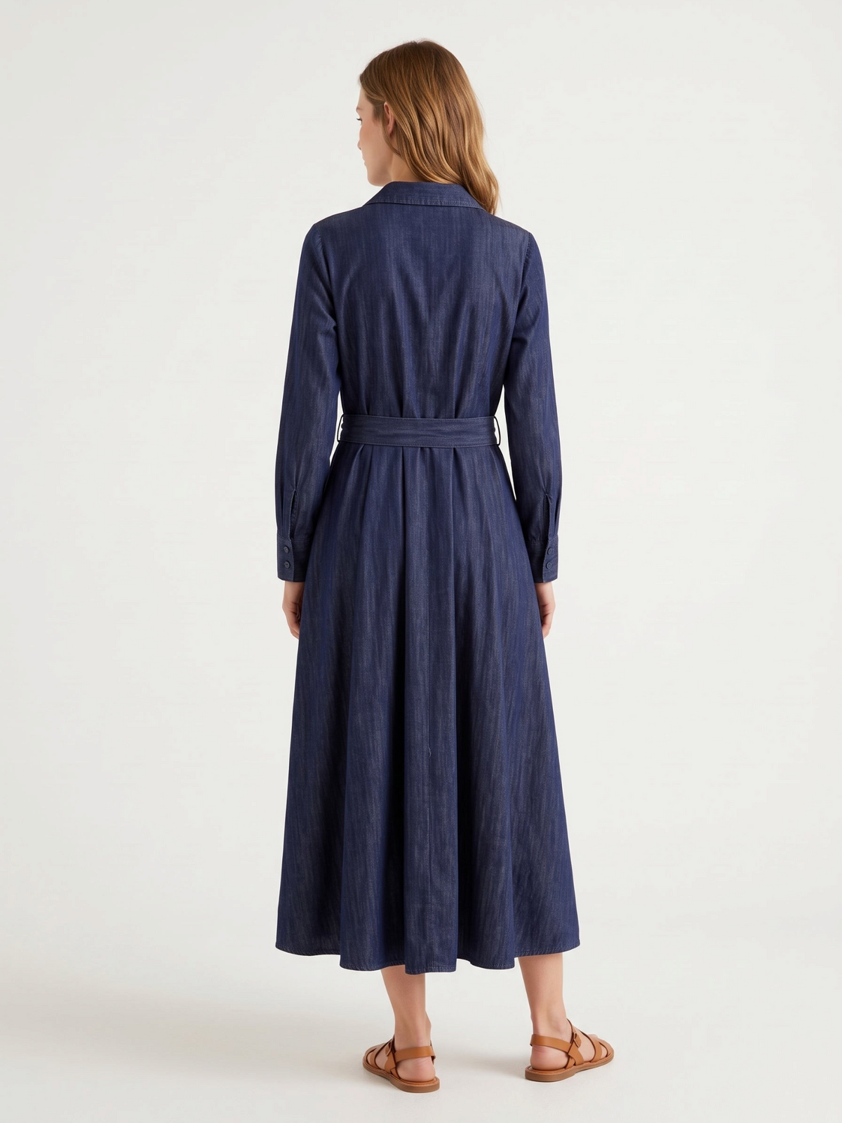 Catherine Martin dark indigo denim shirt dress with long sleeves, belted waist, and A-line skirt, back view.