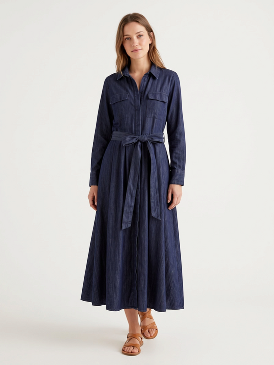 Catherine Martin dark indigo denim shirt dress with a belted waist, long sleeves, and A-line maxi skirt.