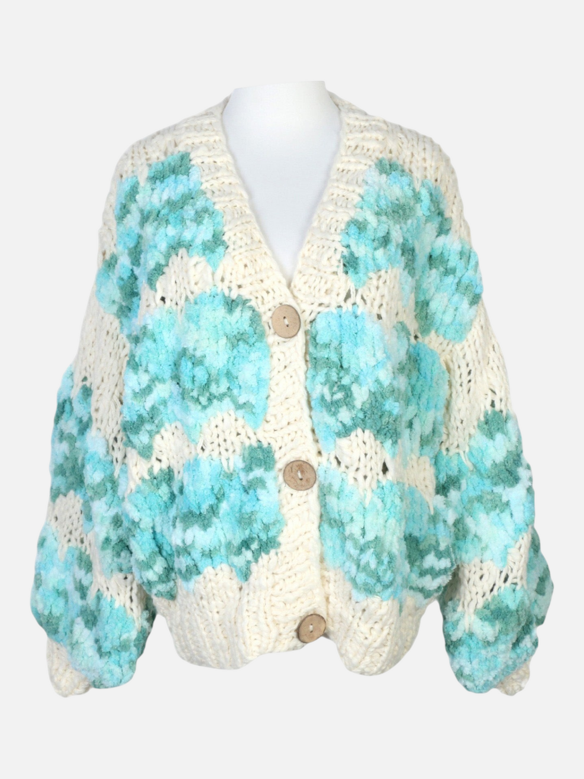 Catherine Martin oversized wool knit cardigan in cream with mint and teal scalloped patterns and button-front closure.