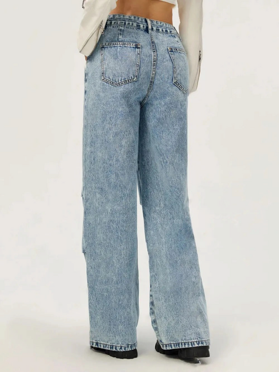 Catherine Martin wide leg cargo jeans in acid wash denim with pleated knee detail, back view on a model.
