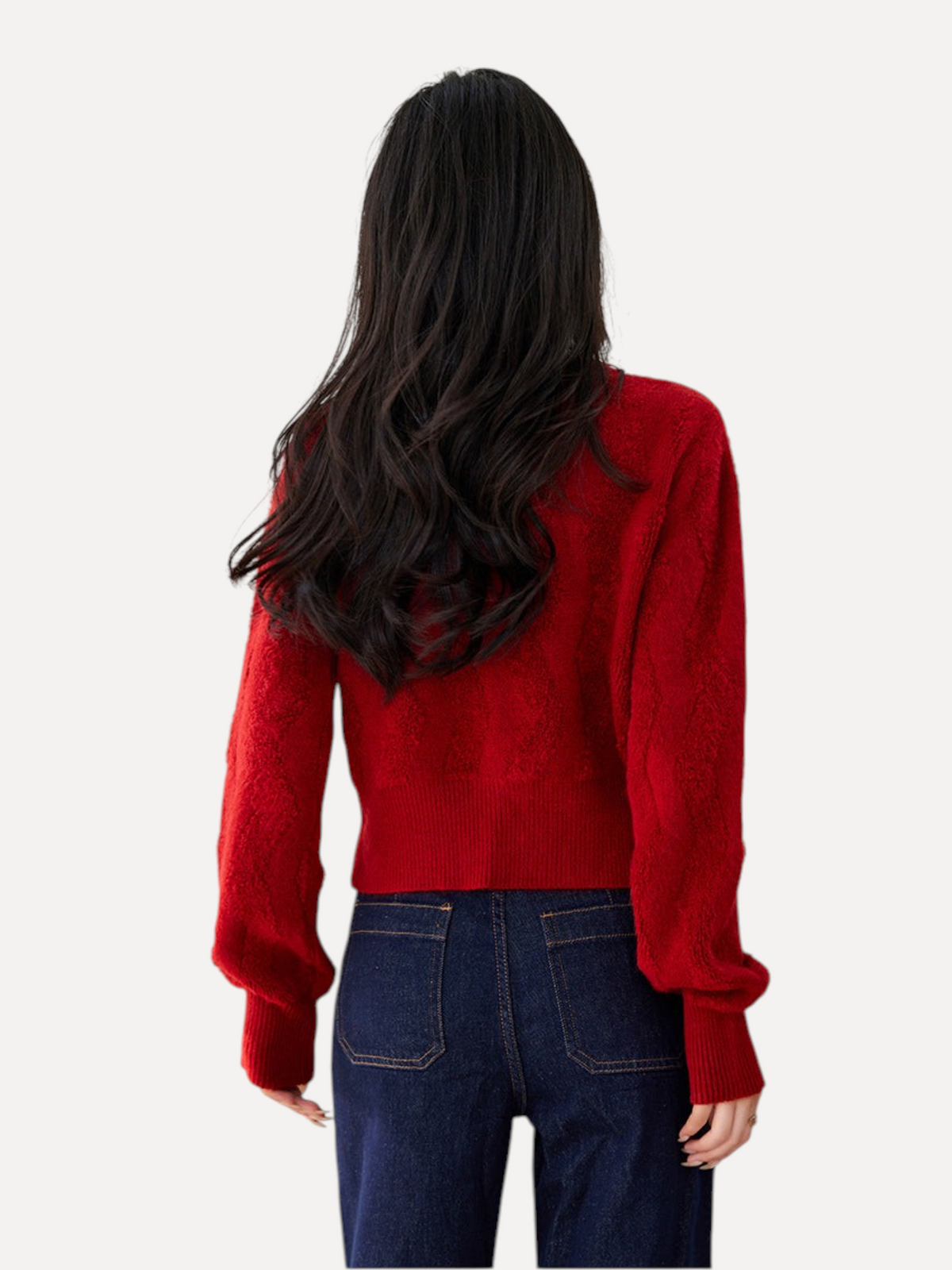 Catherine Martin red textured knit cropped cardigan viewed from the back, worn with dark blue denim jeans.