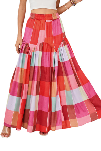 Front view of a red plaid maxi skirt worn by a model indoors, perfect for spring and summer occasions.