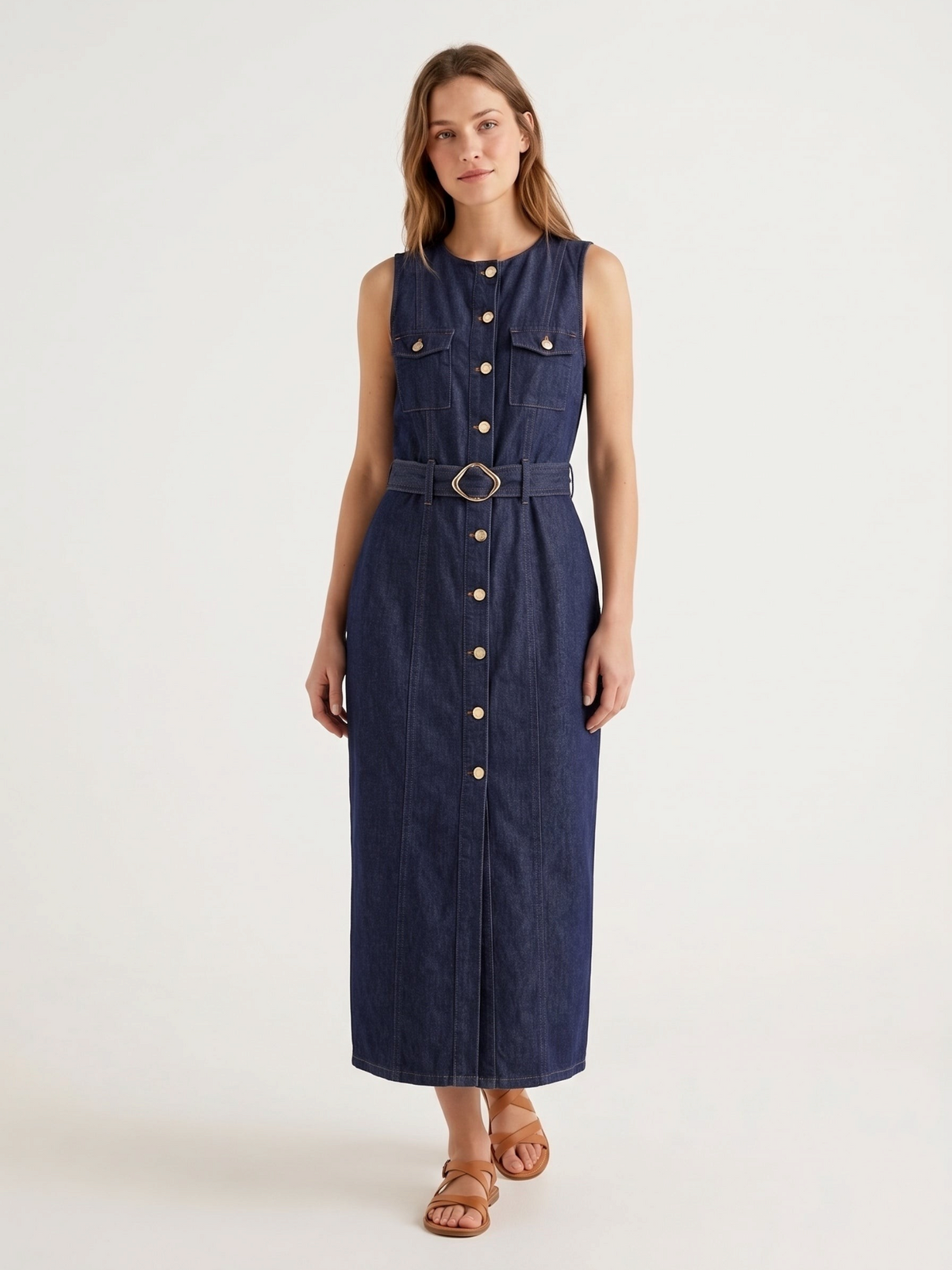 Catherine Martin sleeveless dark indigo denim maxi dress with gold buttons, chest pockets, and a belted waist.