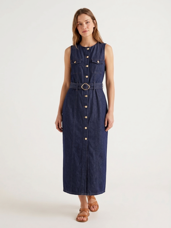 Catherine Martin sleeveless dark indigo denim maxi dress with gold buttons, chest pockets, and a belted waist.