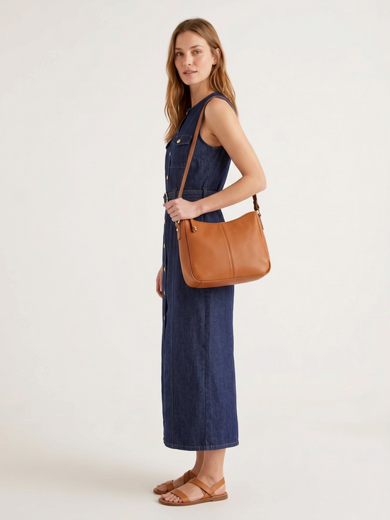 Catherine Martin sleeveless dark indigo denim maxi dress with gold buttons and a belted waist worn by a model