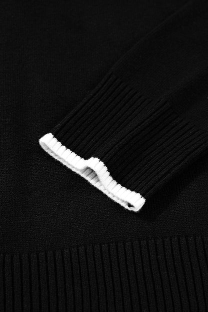 Close-up of a black sweater with a white tag on a black background