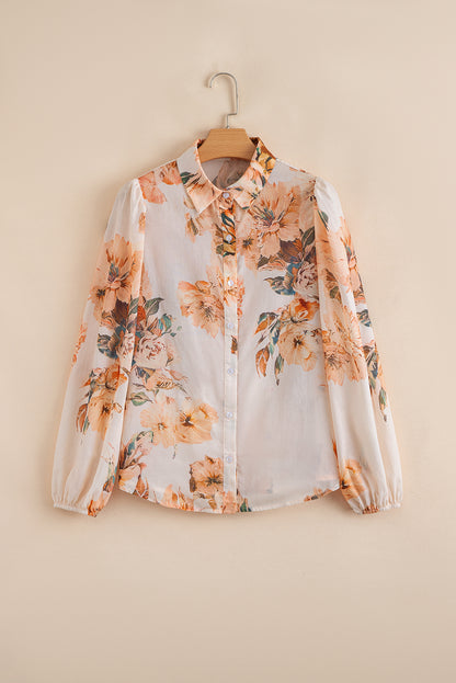 Floral blouse on a hanger against a beige background