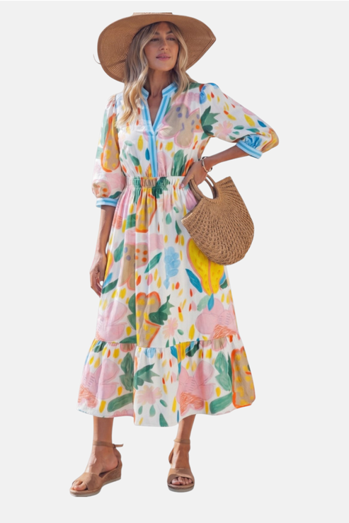 Woman wearing a colorful floral dress with a straw hat and bag on a white background
