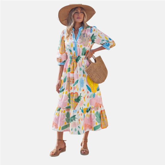 Woman wearing a colorful floral dress with a straw hat and bag on a white background