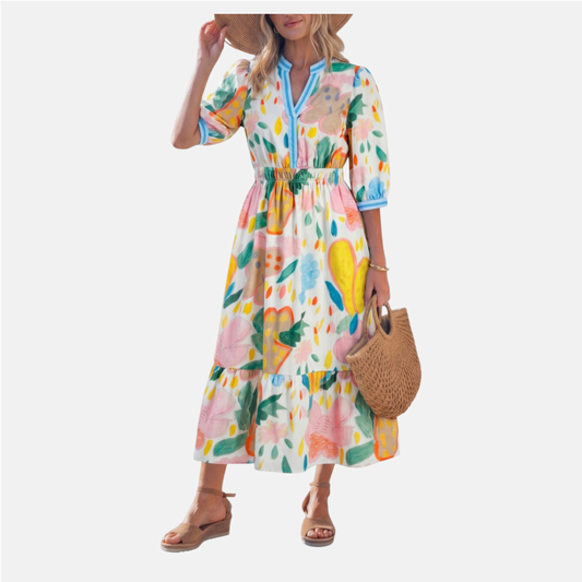 Woman wearing a colorful floral dress with a straw hat and bag on a white background