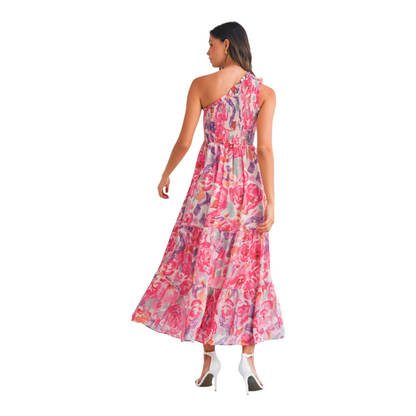 Rear view of a one-shoulder abstract floral maxi dress showing the smocked back panel and a graceful tiered skirt.