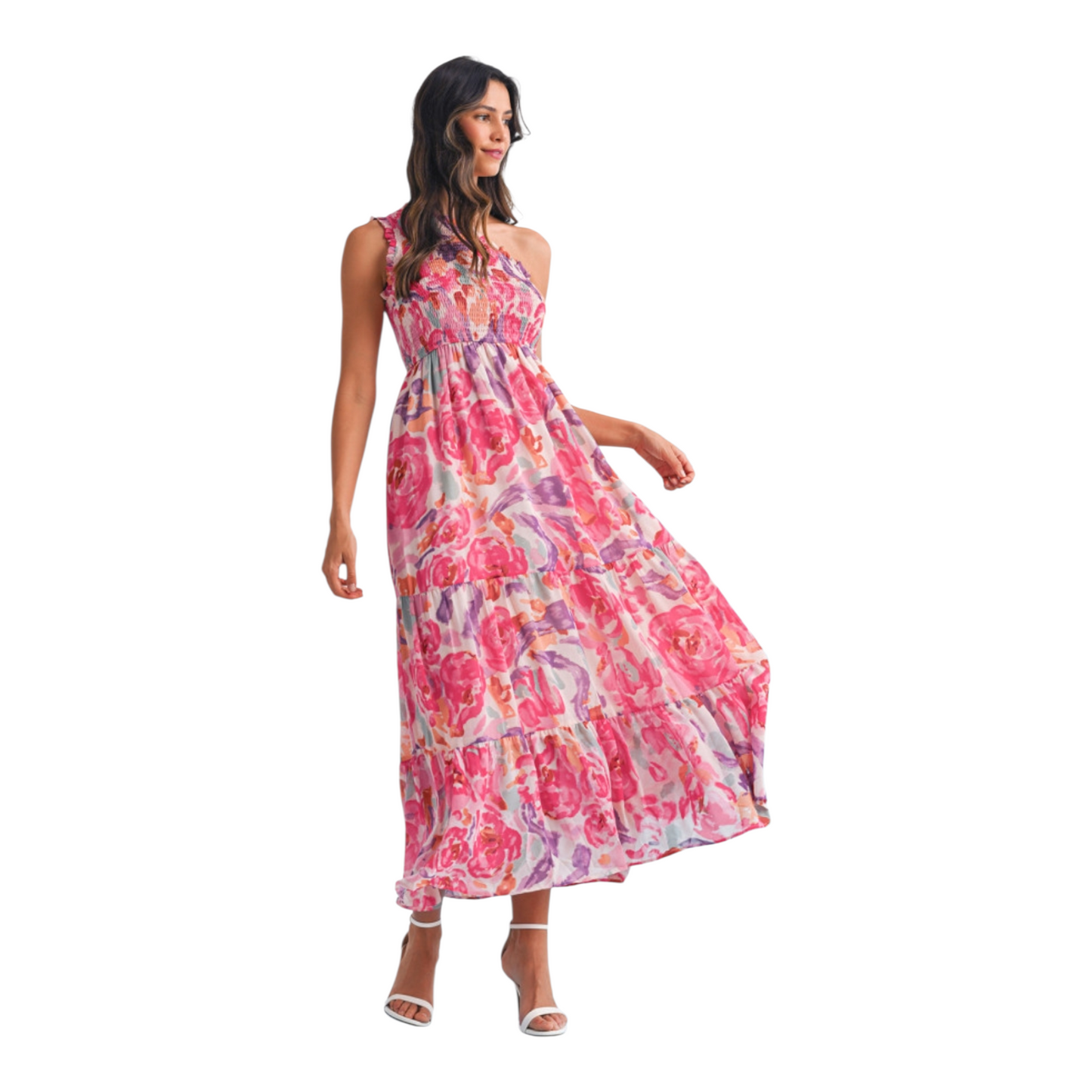 A woman wearing a pink and lilac abstract floral maxi dress featuring a sophisticated one-shoulder neckline and a textured smocked bodice.