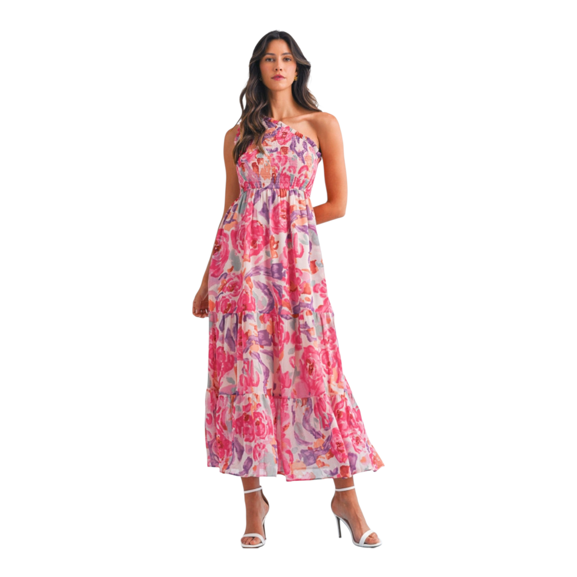 A woman wearing a pink and lilac abstract floral maxi dress featuring a sophisticated one-shoulder neckline and a textured smocked bodice.