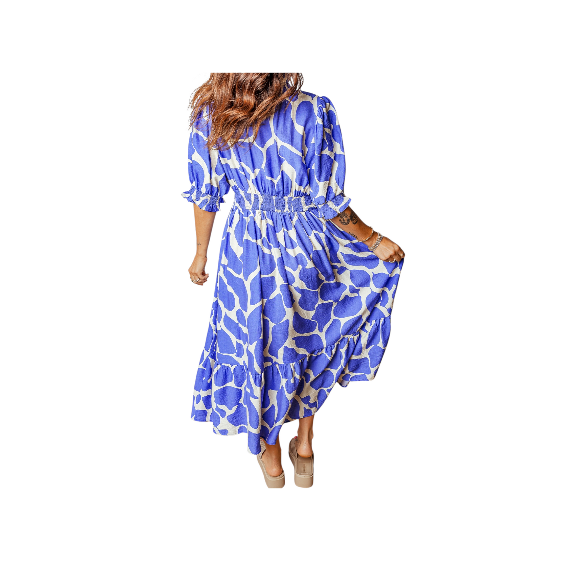 Woman wearing a blue and white patterned dress on a white background