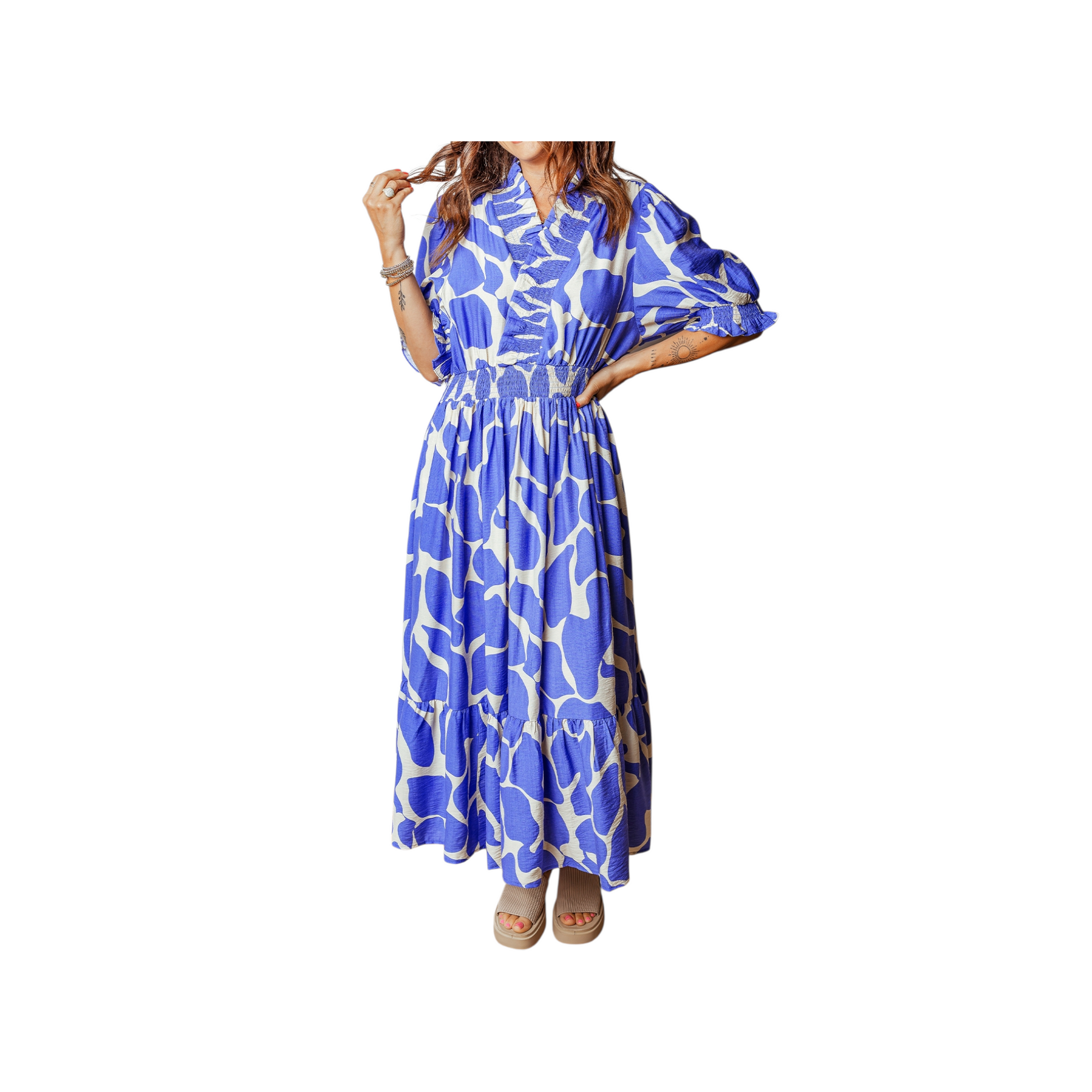 Woman wearing a blue and white patterned dress on a white background