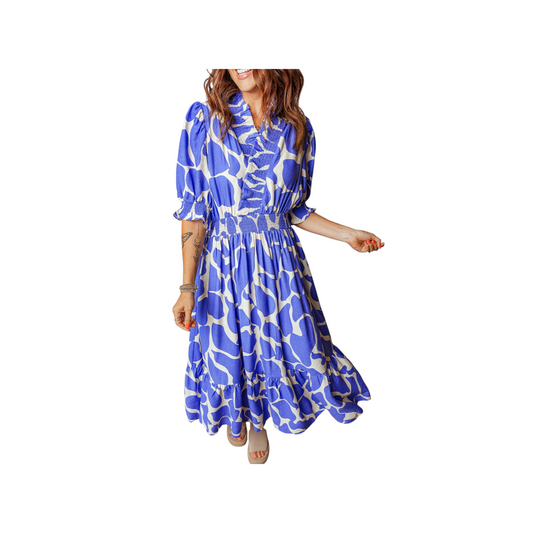 Woman wearing a blue and white patterned dress on a white background