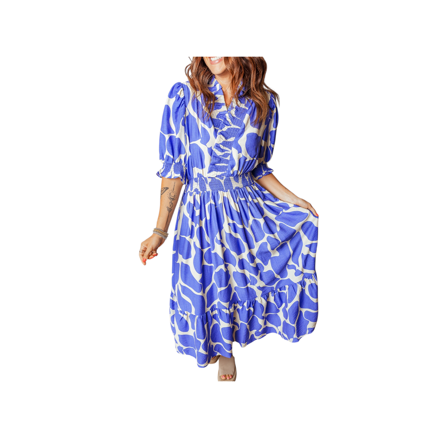 Woman wearing a blue and white patterned dress on a white background
