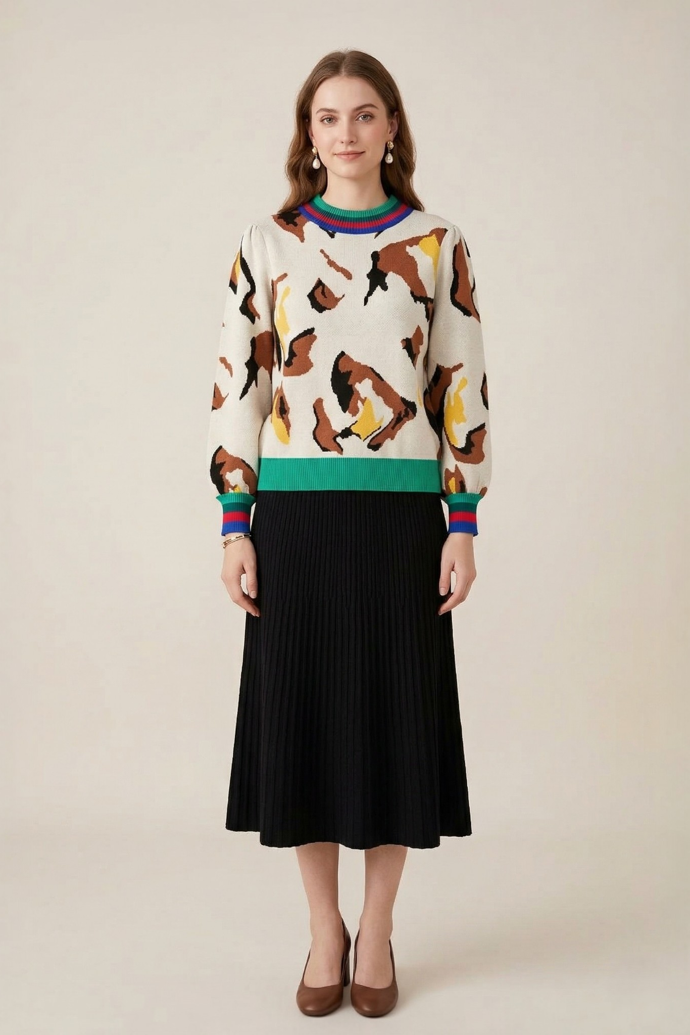 Abstract print stripe trim knit sweater front full length view styled with black pleated midi skirt and brown heels