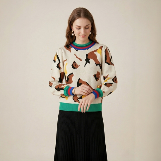 Abstract print stripe trim knit sweater front view showing puff sleeves and multicolour striped cuff detail