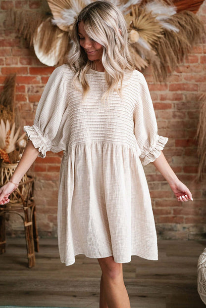 Cute Neutral Tone Loose Dress with Sleeves. Full front view. Indoor setting.