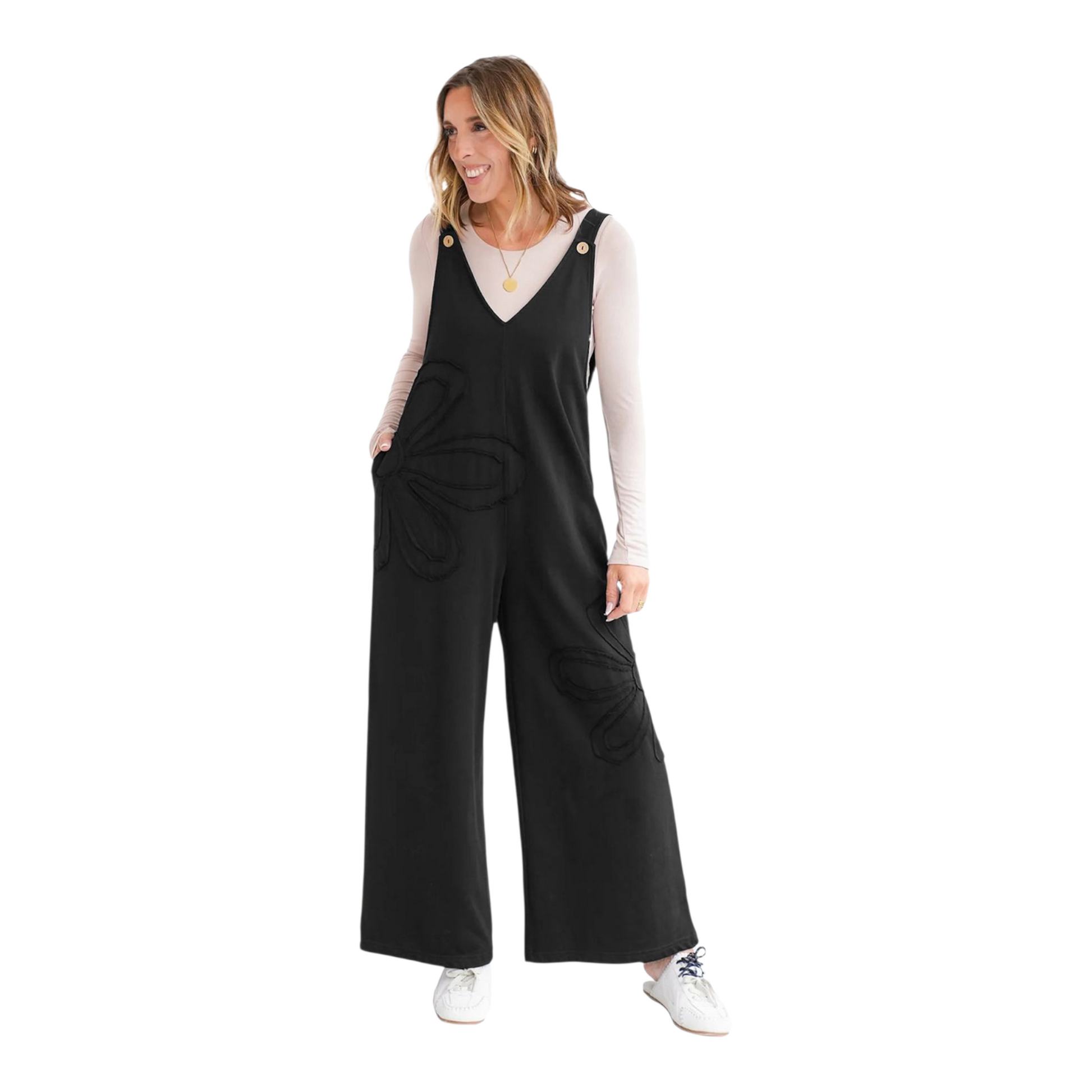 Woman wearing black overalls with a white background