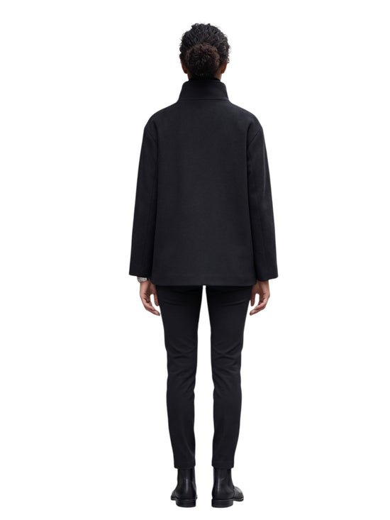 Person wearing a black coat and pants on a white background back profile view