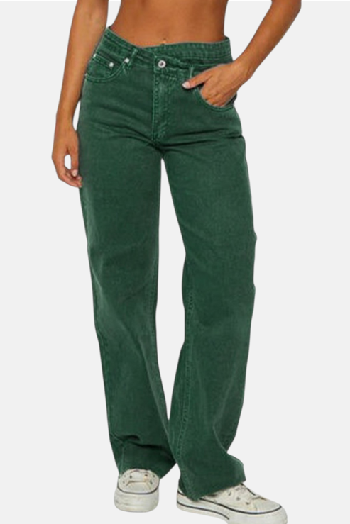 Green jeans worn by a person on a white background
