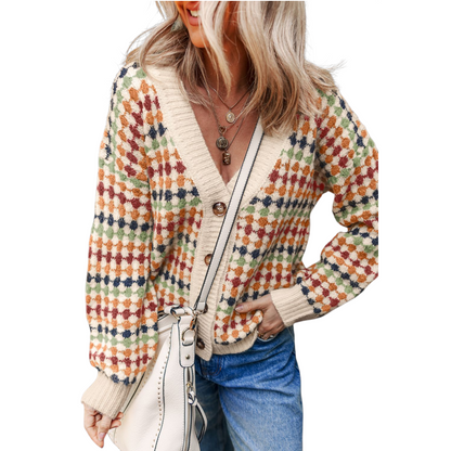 Woman wearing a colorful patterned cardigan with a white background