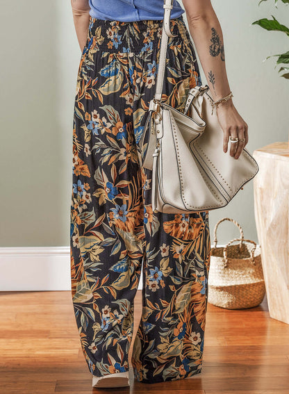 Women's floral wide-leg pants with a shirred tie waist, perfect for summer styling.