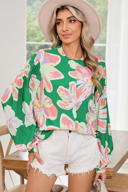 The front view of green floral blouse, featuring pleated long sleeves and front buttons, perfect choice for summer season. 