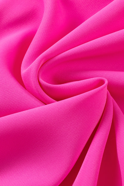 Close-up view of bright pink short-sleeve dress with elegant ruffle details, perfect for parties or weddings in spring and summer.