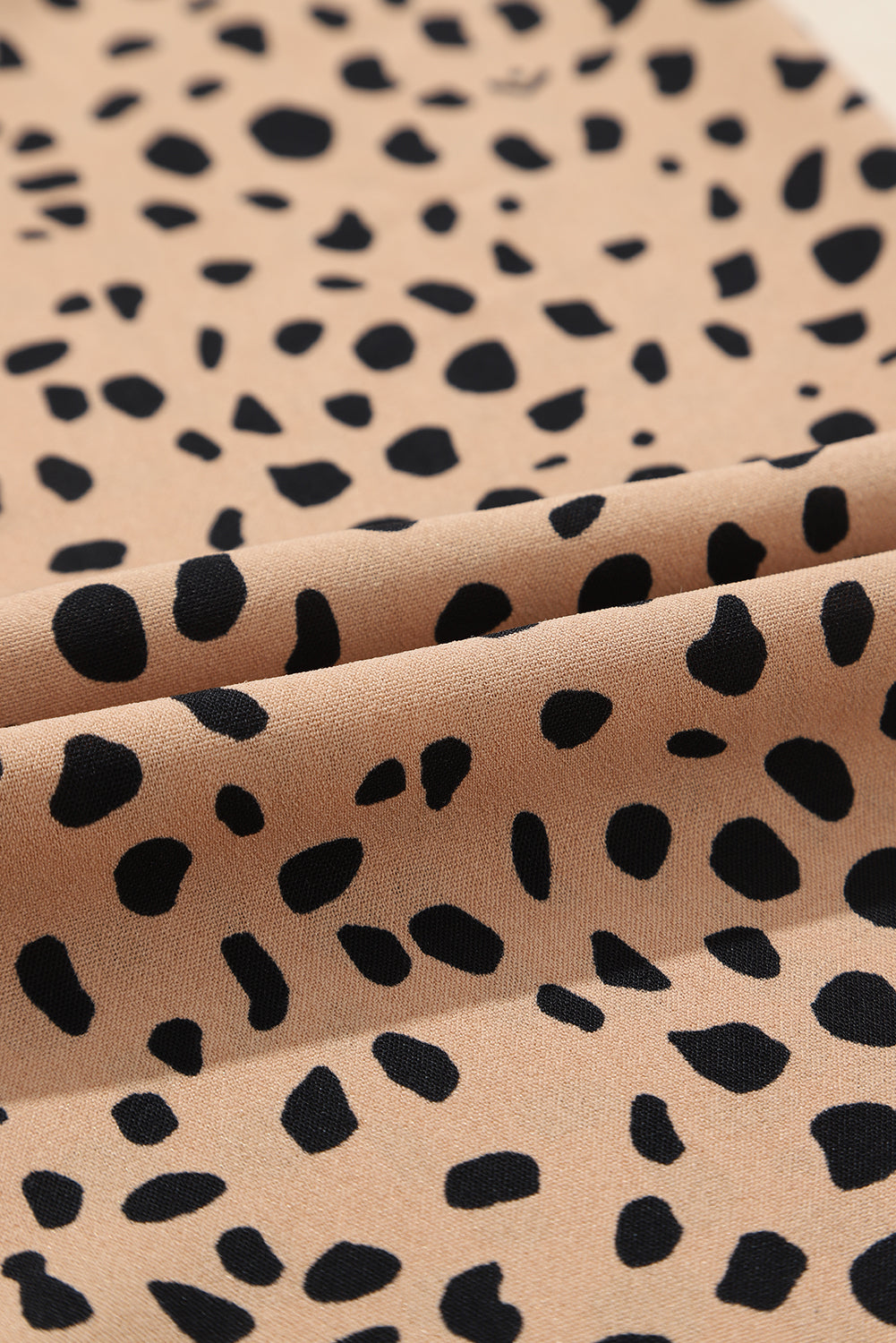 Close-up of khaki leopard print fabric from a blouse with flared long sleeves from Catherine Martin store, Australia.